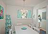 Cottage-white dining area with perfect little chandelier! White and aqua; perfectly beachy!