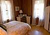 Bedroom 3 with a queen bed and office set up. Complimentary High speed internet and Fax, copier, printer. Bedroom is on the main floor.