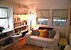 The sofa provides extra seating in this third bedroom/ library.