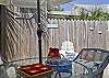 The fully enclosed back yard has a table and chairs ( with umbrella), seating and outdoor art. The outer building in the enclosed backyard/ courtyard also includes the laundry room.