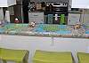 The three bar stool and counter look right into the open kitchen