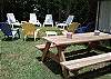 Another view of picnic table and backyard seating area.