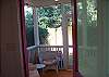 The screened porch is off the back of the cottage. Ideal area to relax and read while looking over the back yard area.