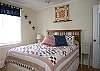 One of two bedrooms downstairs . This is the Queen bedroom.