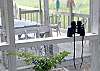 This is the view looking from the screened porch out to the dock building. As the binoculars show- this is great bird watching!