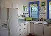 The fully equipped kitchen includes all brand new appliances. Note the sea glass back splas.