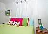 King bedroom. Splashes of color and fun wall hangings make this room a favorite!