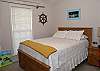 Captain's Quarter Queen bedroom also features a TV. The room also has family heirloom fishing poles, ships wheel, nautical art-- Captain Daniel's favorite room :) Inspired by Daniel's, our dad's and brother's career on the river.