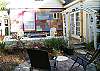 The side patio has seating and also overlooks the garden area.