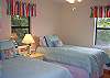 The Hula Bedroom features two twin beds and is on the main floor of the home.