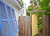Yellow gate at side of cottage leads to side entry door (kitchen entrance).