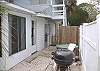 The outside back yard is fenced in. Here is the grill and outdoor shower.