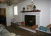 The family room features lots of seating, books, games and TV. It is adjacent to the dining room with an opening to the kitchen to keep the cook in touch with the activity.  The fireplace is non-working however has a great pot with shells and lights to add ambiance!