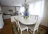 This view is the dining room looking toward the kitchen.  Floor to ceiling windows allow a great amount of natural light to filter into the entire house.