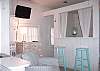 Looking towards the bed room area from the living room club chairs. Note the wall flat screen TV , additional seating