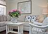 The first floor living room area is a combination of the living room with sofa and cable TV, dining room area with table that seats 6 people.