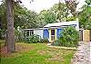 Yellow gate leads to kitchen entrance.