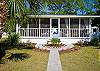 This is the front of the cottage which shows how large the screened porch is- clear across the front! The sign is custom-made by local artist, Pam Martin. An original creation!
