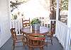 The screened porch includes wicker seating as well as seating for meals or playing cards.