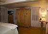 The masterbedroom has windows on all sides with great views of the back yard and garden.