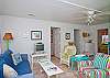 Views of the spacious, open living and dining area. Bright, colorful and fun! This area includes a bar with extra seating; fun place to sit and have a snack!