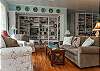 The cottage has a very open layout. This is the large family room with cable TV and library, dining room and even the kitchen. There is also a wood burning fireplace. Tall ceilings and lots of natural lighting.