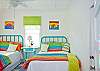 Bedroom #3 with 2 full-size (double) beds. Great, fun color here as throughout the whole cottage!
