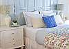 The master bedroom has a tv, large closet and master bath with stained glass windows and vintage tub/ shower.