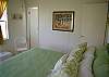Bedroom 2 includes a half bath and view of the marsh.
