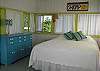 The Guest Cottage features a queen size bed and a partial ocean view. Pure magic! This is a seperate cottage in the behind the cottage with your own door. The cottage is about a 10 step climb up the staris. When the windows are open you can smell the ocean!