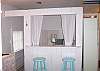 This is the double  bed in the main cottage. There is not an actual door, but there is the half wall and the curtains.