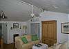 The living room features a HD TV with DVD/ CD player and I-Pod stero dock. The sofa is a sleeper sofa and the front doors over look the screened porch and marsh.
