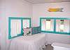 The front of the cottage has a twin day bed which is ideal to relax . You can look at the windows and have a partial ocean view