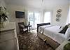 Light, bright and airy describes the ambiance of this room perfectly!  Windows on two sides lets in the morning sunrise.  Enjoy a cup of coffee and the morning newspaper on the private balcony.  There is also a large wall-mounted flat-screen TV.