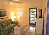 The living room leads to the screened porch. Features a large flat screen TV with DVD and expanded cable. And lots of books and games to enjoy!