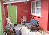 The back of the cottage also has a wonderful private outside seating area. This back door leads to the 2nd bedroom and laundry room