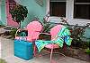 These vintage metal lawn chairs have a long history of mom and pop beach motels up and down the East Coast. These two cheerful pink chairs now grace the front of the cottage!