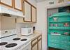 Another view of kitchen. Great aqua china cabinet; this cottage is full of fun color!