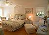 The upstairs bedroom features a queen bed, sitting area and full bath. Lots and lots of natural light.  So relaxing and welcoming- just like the entire cottage.