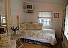 The third bedroom features a twin bed, a tv and lots of books. There is not a door but a curtain to close for privacy.