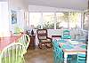 The dining area has a table for 6-8 people as well as the counter seating for 2 more people.