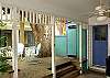 Another view of the deck and outdoor shower. The bright blue door leads to the laundry room.