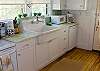 The kitchen features the washer and dryer in addition to a fully equipped kitchen