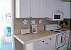 The kitchen leads right out to the screened porch.