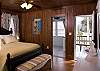 The Master bedroom features a queen size  bed with private bath and screen door leading to porch overlooking the pool and catching the morning sun. Comfortable bedding and pillows with Pine Cone Hill linens. Accented with paintings by a local starving artist.