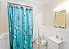 The cottage features two full bathrooms. There is NOT a tub in either bathroom- just shower.