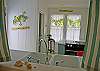 Looking into the kitchen from the dining room area. Kitchen features the owners personal chef quality stove and oven! They love to cook and want the best for you, our guests!