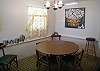 The kitchen features the original curtains from the 1960's as well as a large piece of art created by Catherine Lovett. We love this large picture of an oyster basket.