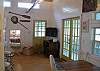 This door leads out to the large screened side porch. This is the large TV .  The home has beautiful wood floors.