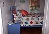 Bedroom 2 has a queen bed and leads to the outdoor private shower. Filled with art and bright , cheerful colors!